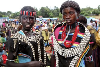 Young woman wearing pearls and traditional clothing at a lively market