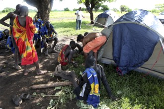 Mursi people in a tent camp under a tree, Mago National Park, Ethiopia