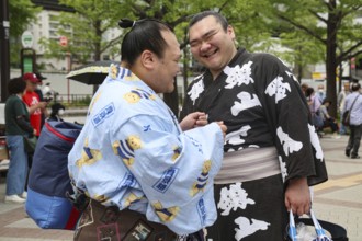 Two sumo wrestlers joke at an event in Tokyo, Tokyo, Ryogoku, Japan