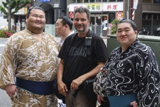 Two sumo wrestlers with a tourist in Ryogoku, Tokyo, Ryogoku, Japan