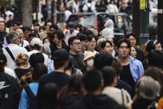Crowded street scene with many passers-by on Dogen-zaka Street, Tokyo, Japan