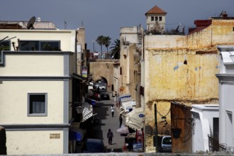 Narrow street through old walls and buildings under sunny sky, El Jadida, Cité Portugaise, Morocco