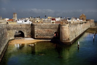 Towering fortress walls on the edge of a body of water, El Jadida, Cité Portugaise, Morocco