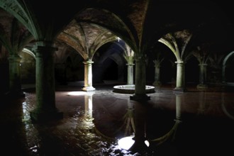 Dark cistern with gothic arches and reflecting water surfaces in El Jadida, El Jadida,