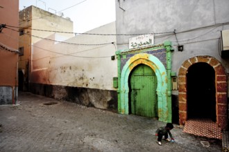 A quiet alley with colorful gates and historic buildings in an abandoned atmosphere, El Jadida,