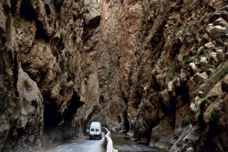 A white vehicle drives through the narrow section of Dadès Gorge, Dadès Gorge, Morocco