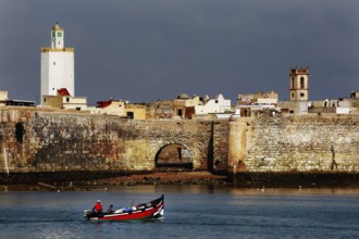 Historic seaside fortress with a small boat in the foreground, El Jadida, Cité Portugaise, Morocco