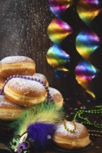 Berliner with powdered sugar, pearl necklaces and colorful bows, carnival atmosphere, carnival