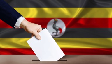 Hand placing a ballot in ballot box with the Ugandan flag in the background. Uganda presidential