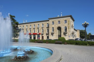 Classic building with fountain and beautiful summer atmosphere under blue skies, Stalin Park and