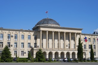 Impressive classic building with dome and pillars under a clear blue sky, City Hall, Gori,