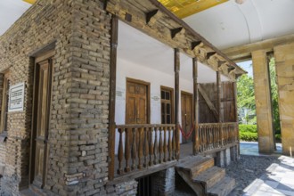 Rustic wooden veranda on a brick building with wooden windows, Josef Stalin's birthplace, Gori,