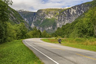 Åndalsnes, Møre og Romsdal province, Norway, Winding road with a motorcycle surrounded by green