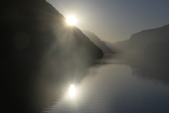 Foggy morning atmosphere over the quiet Lysefjord at sunrise between mountains
