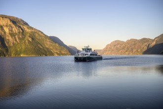Columbus shipping company ferry moves through the Lysefjord with mountains in the background in the