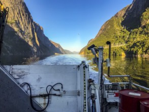 Lysebotn, Rogaland Municipality, Norway, View from a boat of the sunny Lysefjord surrounded by high