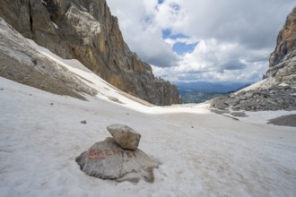 Guide to Rifugio Brentei on a rock, remains of the Vedretta dei Camosci glacier, Brenta Mountains,