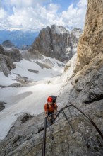Mountaineer climbs a ladder, Via Ferrata dell'Ideale via ferrata, spectacular mountain landscape