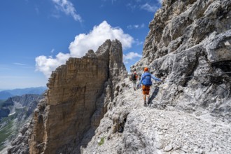 Two mountaineers on the Via Ferrata Brentari via ferrata, spectacular mountain landscape with steep