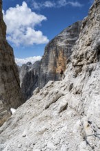 Climbers on the Via Ferrata Brentari via ferrata, spectacular mountain landscape with steep cliffs,