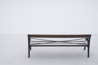 Bench in snow, wintery Turku or Swedish Åbo, Varsinais-Suomi, Finland