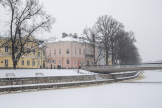 Historic buildings on the frozen Aurajoki river, wintery Turku or Swedish Åbo, Varsinais-Suomi,