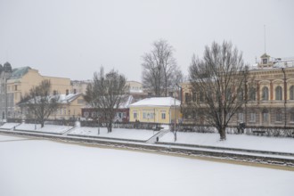 Pharmacy museum and other historic buildings on the frozen Aurajoki river, wintery Turku or Swedish