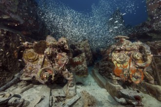 Underwater photo of two diesel engines of sunken sunken small disintegrated broken apart fishing