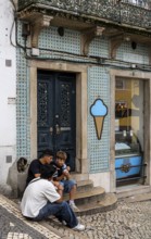 Young people eating ice cream, old town on Rue Padarias, Sintra, Lisbon, Portugal