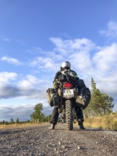 Idre, Dalarnas län, Sweden, BMW G 650 GS Sertao enduro motorcyclist posing on a gravel road under a