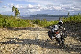 Lövdalen, Jämtland County, Sweden, A dirt road leads through slightly wooded terrain with a BMW G