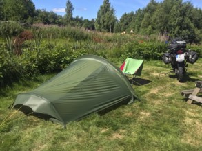 Växjö, Kronobergs län, Sweden, green campground with camping chair and BMW G 650 GS Sertao enduro