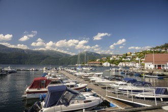 Sand, Rogaland Municipality, Norway, boats in harbor on a sunny day with mountains in the