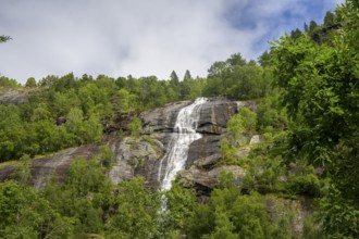 Åndalsnes, Møre og Romsdal Province, Norway, High Waterfall flows over steep rocks surrounded by