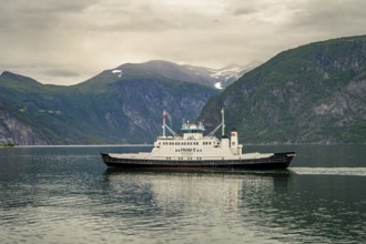 Valldal, Møre og Romsdal province, Norway, Fram Geiranger ferry in calm water surrounded by high