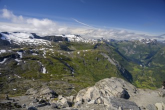 Geiranger, Møre og Romsdal province, Norway, view over snow-capped mountains and a green valley
