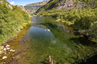 Røldal, Vestland, Norway, Idyllic lake with a clear reflection surrounded by green mountains in the