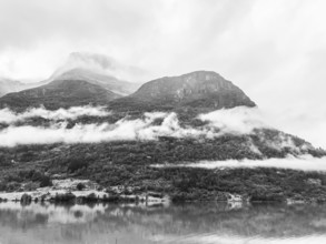 Olden, Vestland, Norway, black and white landscape of mountains with low-hanging clouds and