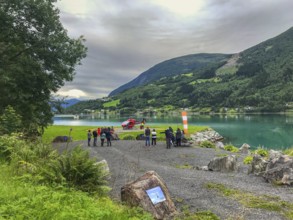 Loen, Vestland, Norway, fjord scenery with gathered people Cruise tourists waiting for a