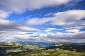 Tylldal, Innlandet, Norway, vast landscape with mountains and dramatic sky surrounded by greenery