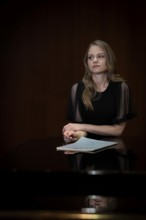 Young woman, pianist, in evening dress, with notes by Johann Sebastian Bach, supported on Steinway