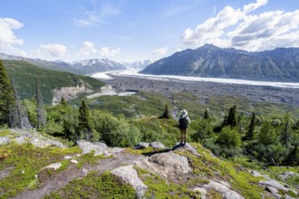 Young man enjoying the view, view of impressive mountain landscape with Matanuska glacier and
