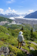 Young man enjoying the view, view of impressive mountain landscape with Matanuska glacier and