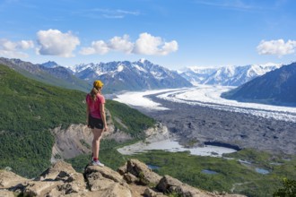 Young woman enjoying the view, view of impressive mountain landscape with Matanuska glacier and
