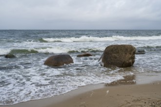 Boulders and waves on the coast, sandy beach, Baltic resort Göhren, Baltic Sea, Rügen island,
