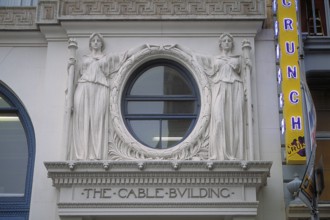 Two female sculptures above the entrance to the historic Cable Building, built in 1894 in Beaux