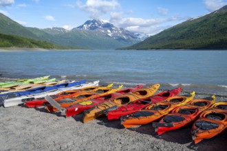 Colorful kayaks on lakeside, lake and mountains, Eklutna Lake, Chugach Mountains, Chugach State