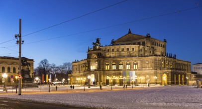 Illuminated Semper Opera House and Theatre Square with snow at dusk, Old Town of Dresden, Saxony,