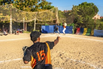 Players on a dusty baseball field engaging in a competitive game, with a pitcher winding up to