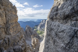 View from the Bocca degli Armi gap, mountaineers on a rock band on the Via Ferrata Bocciere
